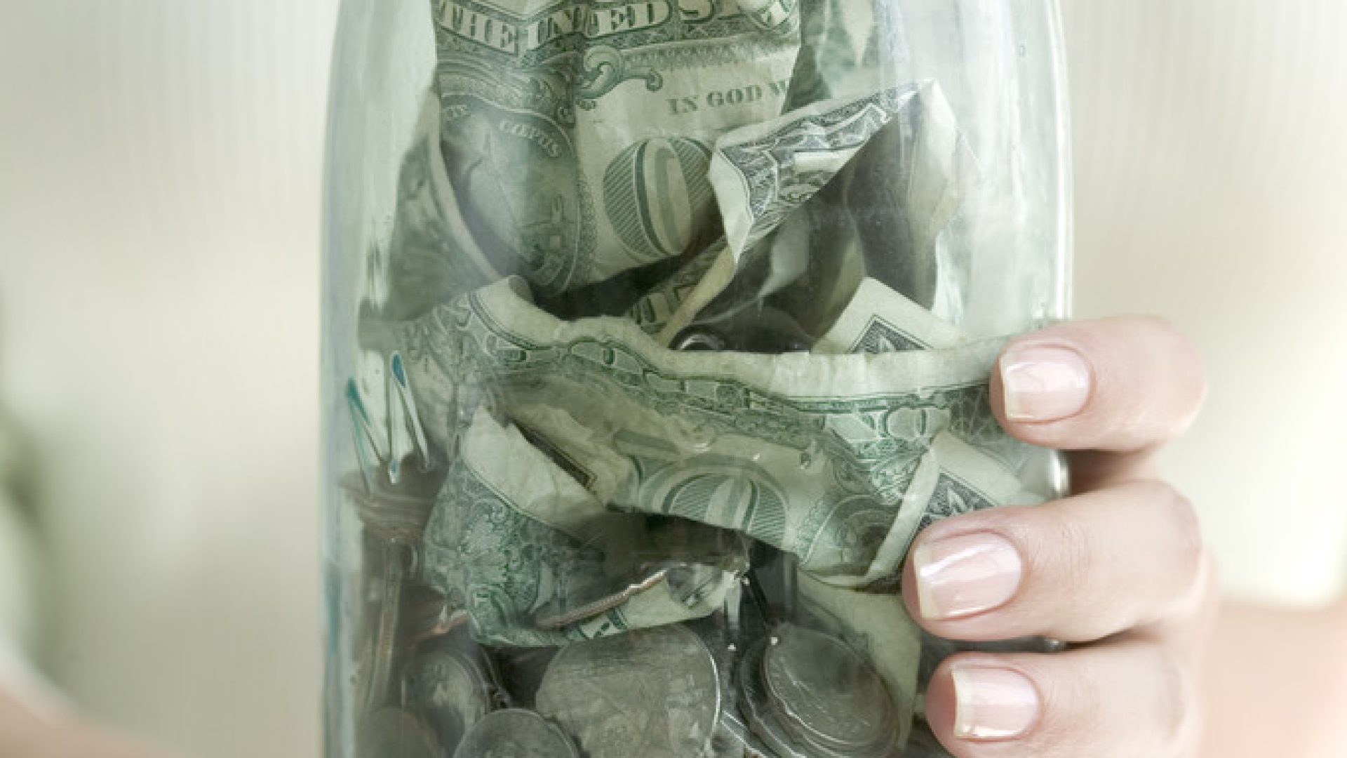 Jar of Money --- Image by © Royalty-Free/Corbis